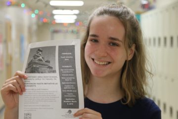 Sophomore, Lauren Loveless grabs a flyer for upcoming trip in summer to Japan.