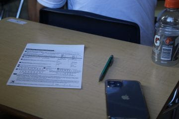 A student recieved their voter registration card during Dr. Chapman's government class.