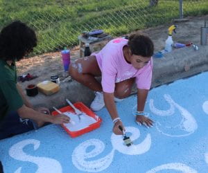 students painting parking spots