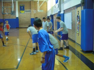 7th period gym class is playing arena football for the first time this year . Nathan Robertson [8] (far right ) is getting ready to throw the football in the old gym .