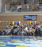 The Jag swim team supports each other at a competition. Photo by Mikey McGinnis
