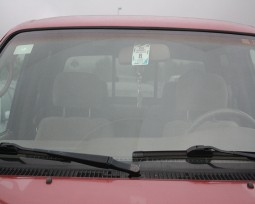 Parking passes hang from the rearview mirror so they are visible at all times.