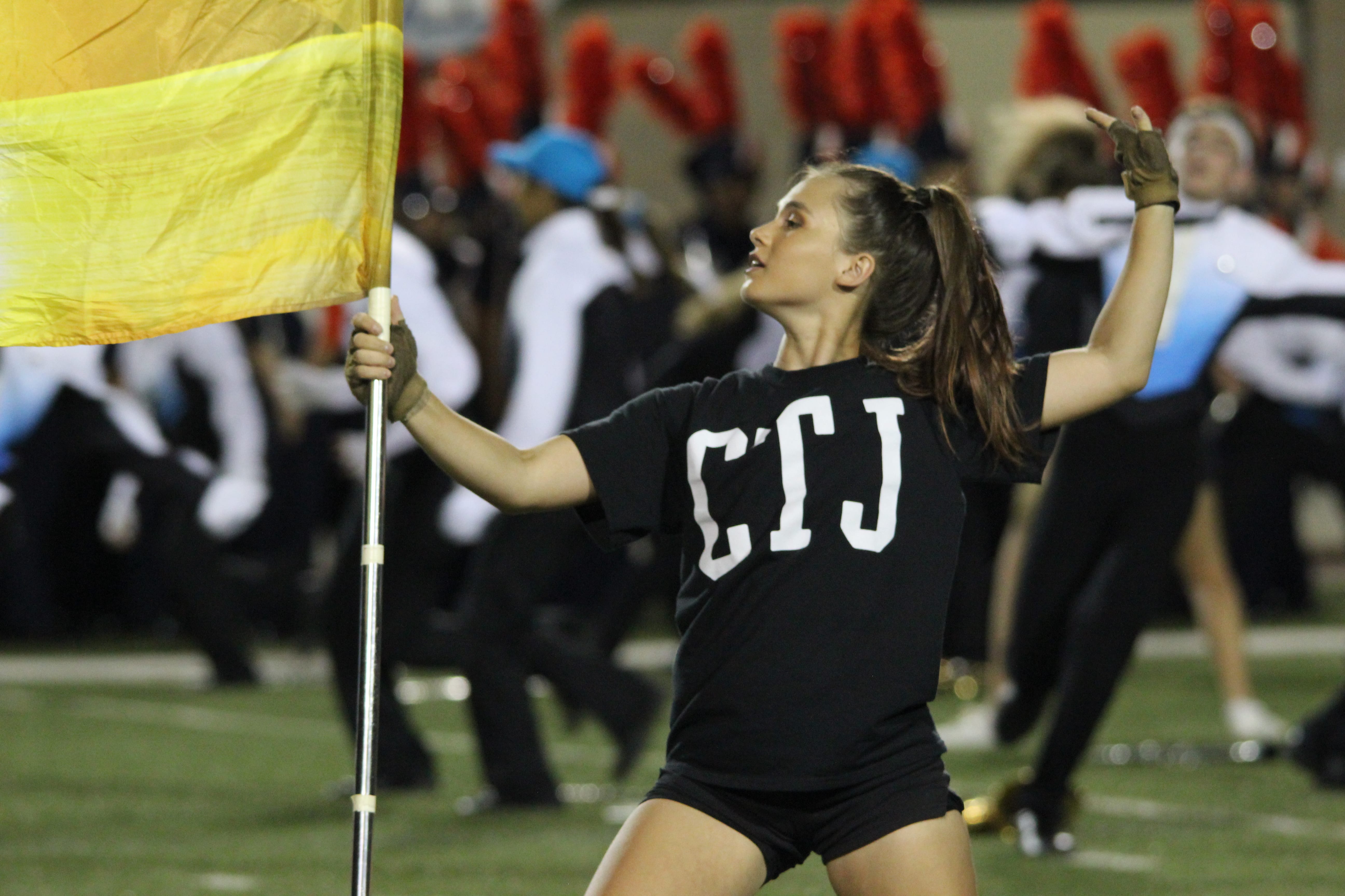 Maddie Chondra dances while performing for color guard during the halftime performance against Brandeis. Photo by Adelin Blackmon