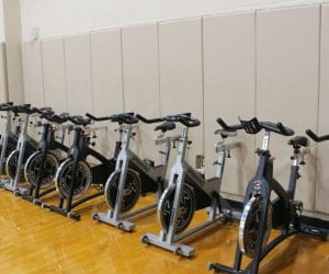 The spin bikes the Lifetime Fitness and Wellness class uses are lined against the walls of the gym.