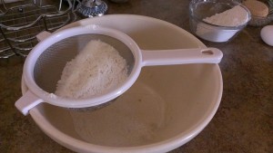 Passing the dry ingredients through a sieve ensures the lightest possible batter. 