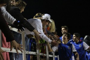 Players and Blue Crew members celebrate the win after with their traditional high five gauntlet. Photo by Jacob Dukes