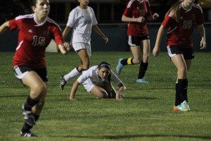 Megan Baer, 12, gets knocked down in last Friday's rough match-up. Photo by Jacob Dukes