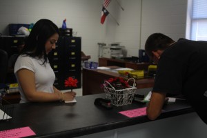 Students always get a tardy slip when they're let to school. Featuring senior Aliah Villarreal and senior Jason Ross. Photo by: Stephanie Smith