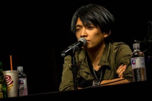 Monty Oum talking at a panel at a convention. Photo by roosterteeth.wikia.com