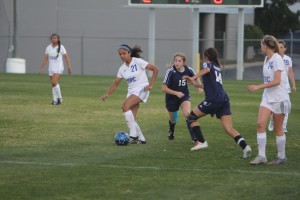 Junior Hailey Terrell receives a pass from a teammate and attempts to evade two defenders. Photo by Jacob Dukes