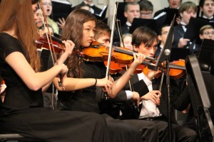 Violin section of the Orchestra perform in a December concert.  Photo by: Amparo Gil