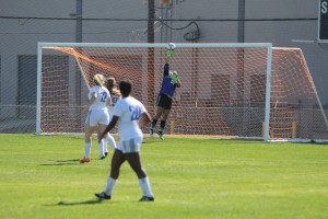 Junior Mary Cardone hits the ball away to record a save. Photo by Jacob Dukes