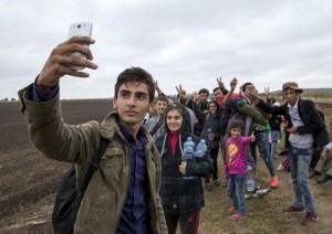 A syrian teen takes a selfie on the long walk to safety. 