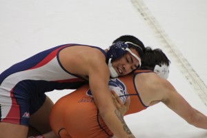 Senior Grant Oshiro takes down a Madison competitor in the overtime round. The victory ensured his spot at state. 