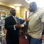 Councilman Keith Toney visits with Mr. Bell in the library Tuesday. Shelfies with the councilman was an opportunity to promote the library and for the public meet the new councilman. Photo by Francisco Turrubiates.