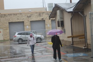 Students walk in the rain to the portables. The move to the ROTC parking lot has removed the threat of walking across a flooded Ray Bon. 