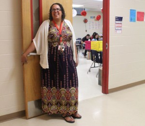 English III teacher Natasha Christian welcomes students at her door before first period. The English II and III teams moved to Saber building this year. Photo by Irene Ybarra.